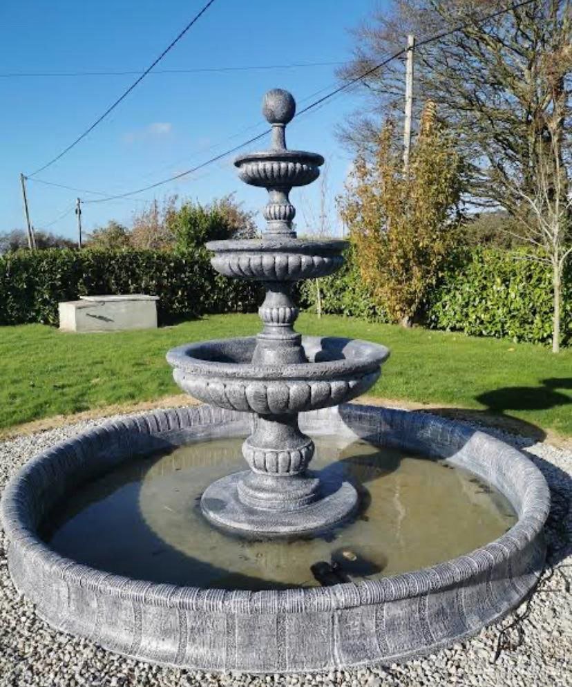 Minimalist cascade fountain in an indoor atrium.